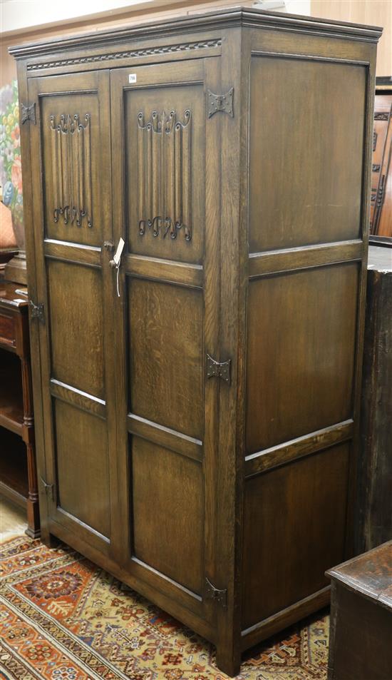 An early 20th century linenfold wardrobe W.110cm